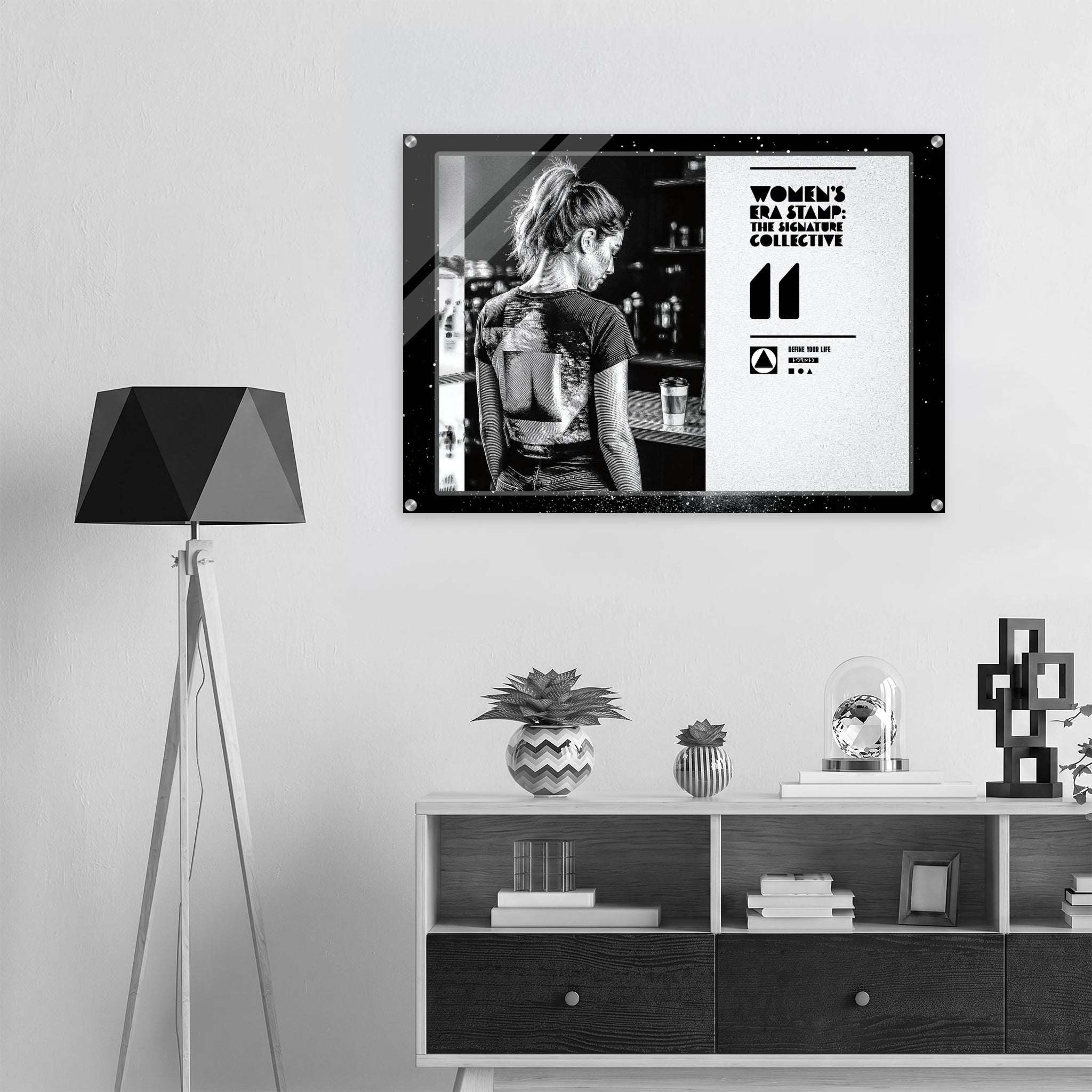 Framed poster of a woman with a tattoo on her back in a room with a lamp and shelves.