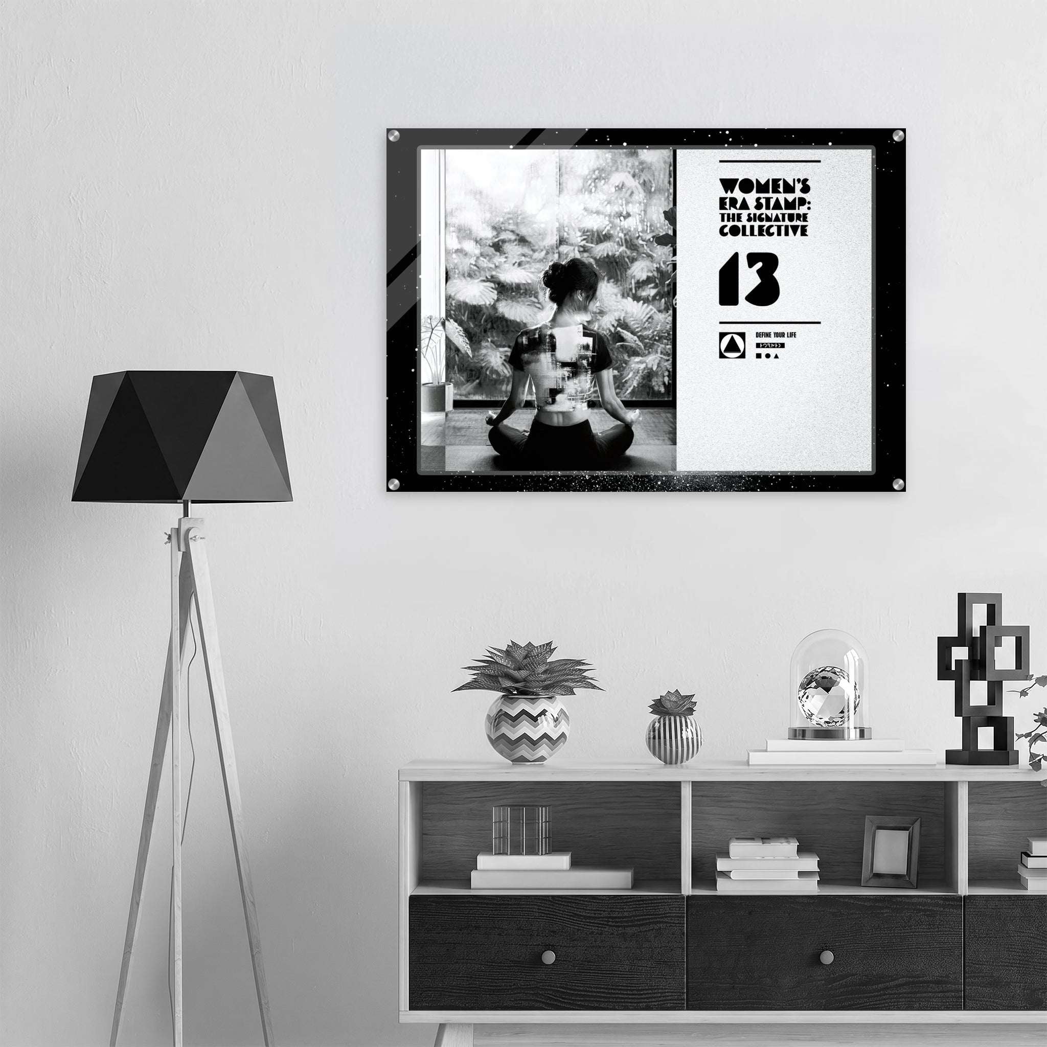 Framed artwork on a wall above a shelf with decorative items