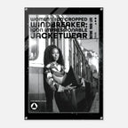 A black-framed poster or print featuring a black-and-white photograph of a woman standing beside a train, with large text reading 'WOMEN'S ICON CROPPED WINDBREAKER: ICON IMPRESSIONABLE JACKETWEAR' and smaller text 'DEFINE YOUR LIFE'.
