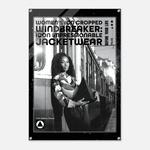 A black-framed poster or print featuring a black-and-white photograph of a woman standing beside a train, with large text reading 'WOMEN'S ICON CROPPED WINDBREAKER: ICON IMPRESSIONABLE JACKETWEAR' and smaller text 'DEFINE YOUR LIFE'.