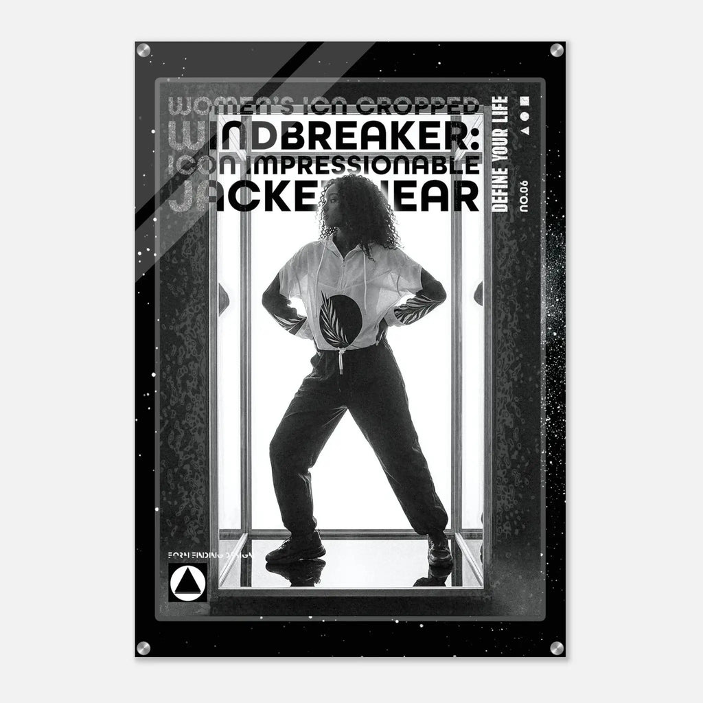A black and white poster-style product featuring a silhouetted person standing in front of vertical bars, with large text reading 'WOMEN'S ICON CROPPED WINDBREAKER: ICON IMPRESSIONABLE JACKETWEAR' and smaller text 'DEFINE YOUR LIFE.' The poster has a dark border with small metallic corner details and is shown against a light gray background.