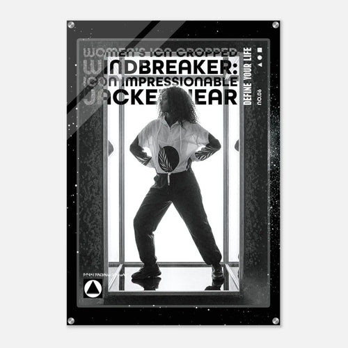 A black and white poster-style product featuring a silhouetted person standing in front of vertical bars, with large text reading 'WOMEN'S ICON CROPPED WINDBREAKER: ICON IMPRESSIONABLE JACKETWEAR' and smaller text 'DEFINE YOUR LIFE.' The poster has a dark border with small metallic corner details and is shown against a light gray background.