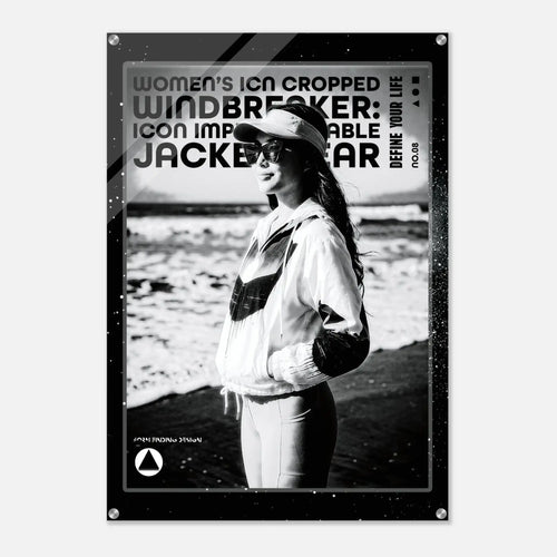A black and white poster print featuring a woman in a windbreaker jacket on a beach, with bold text reading 'WOMEN'S ICON CROPPED WINDBREAKER: ICON IMPRESSIONABLE JACKETWEAR 'DEFINE YOUR LIFE' and a small logo at the bottom.