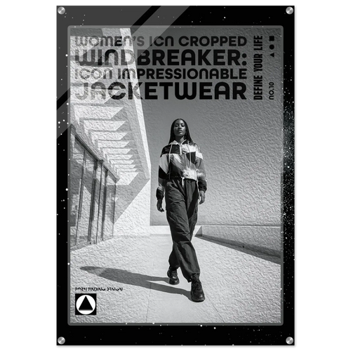A black and white promotional poster or print featuring a woman walking outdoors in a striped jacket and pants, with large text reading 'Women's Icon Cropped Windbreaker: Icon Impressionable Jacketwear' and smaller text 'Define Your Life.' The print has a black border with small silver corner hardware and is shown against a light neutral background.