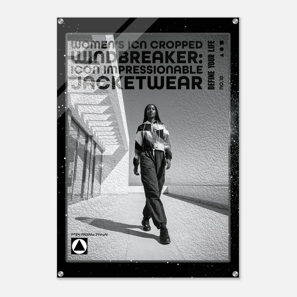 A black-framed poster or print featuring a black-and-white fashion photo of a woman walking outdoors, with large text reading 'WOMEN'S ICON CROPPED WINDBREAKER: ICON IMPRESSIONABLE JACKETWEAR' and smaller text 'DEFINE YOUR LIFE'.