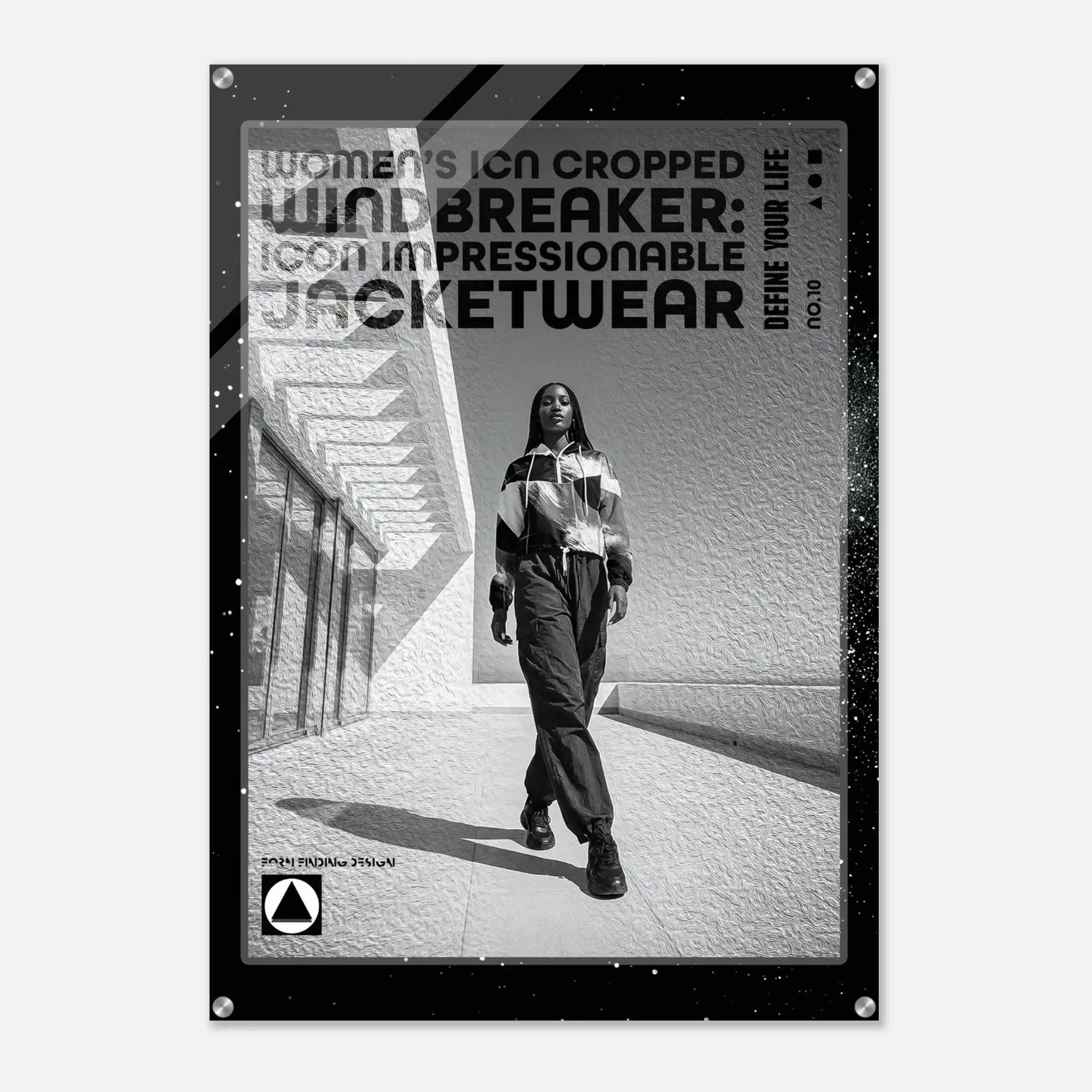 A black-framed poster or print featuring a black-and-white fashion photo of a woman walking outdoors, with large text reading 'WOMEN'S ICON CROPPED WINDBREAKER: ICON IMPRESSIONABLE JACKETWEAR' and smaller text 'DEFINE YOUR LIFE'.