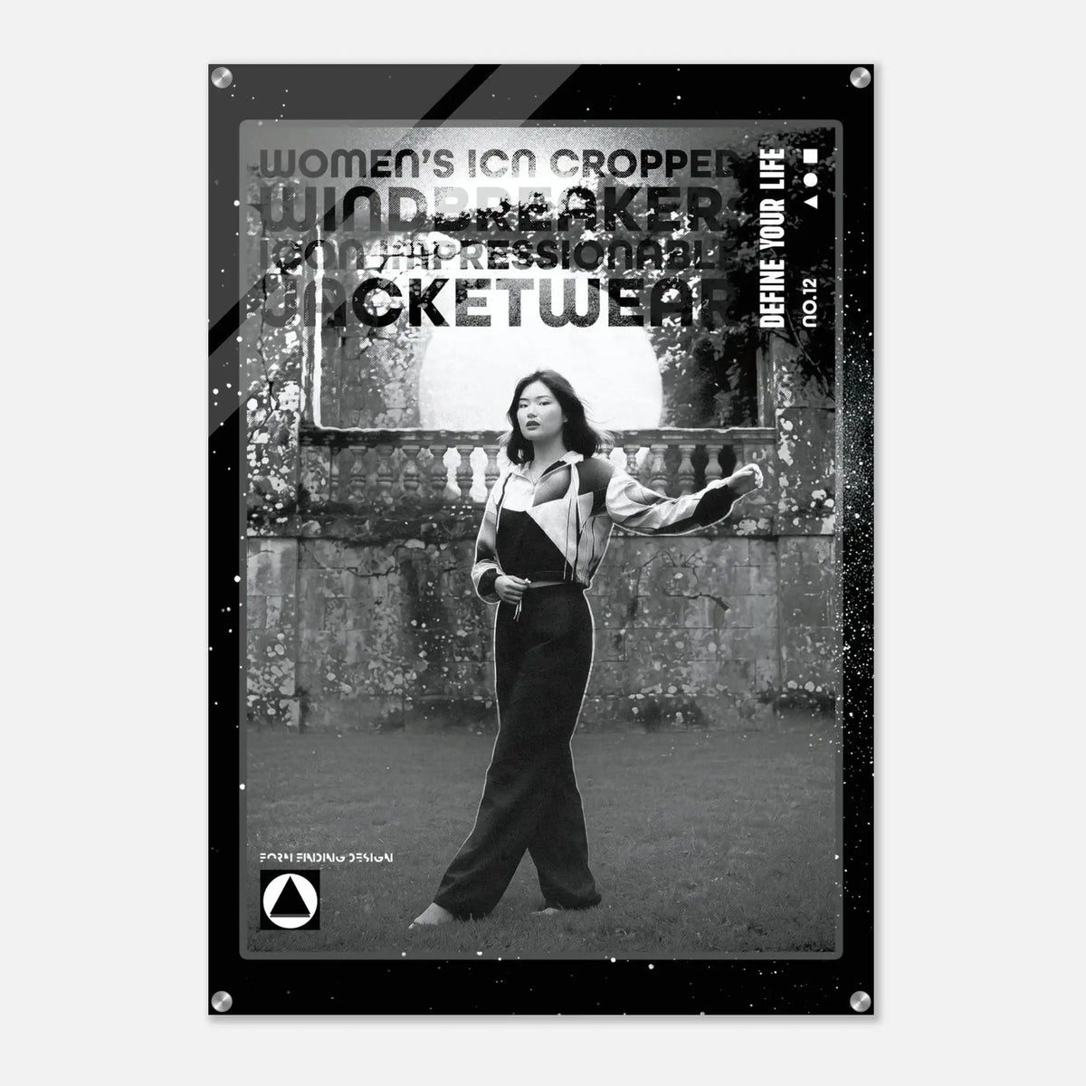 A black and white fashion poster featuring a cropped photo of a woman in a jumpsuit, with bold distressed text including 'WOMEN'S ICON CROPPED WINDBREAKER'. The poster is shown hanging against a light gray wall.