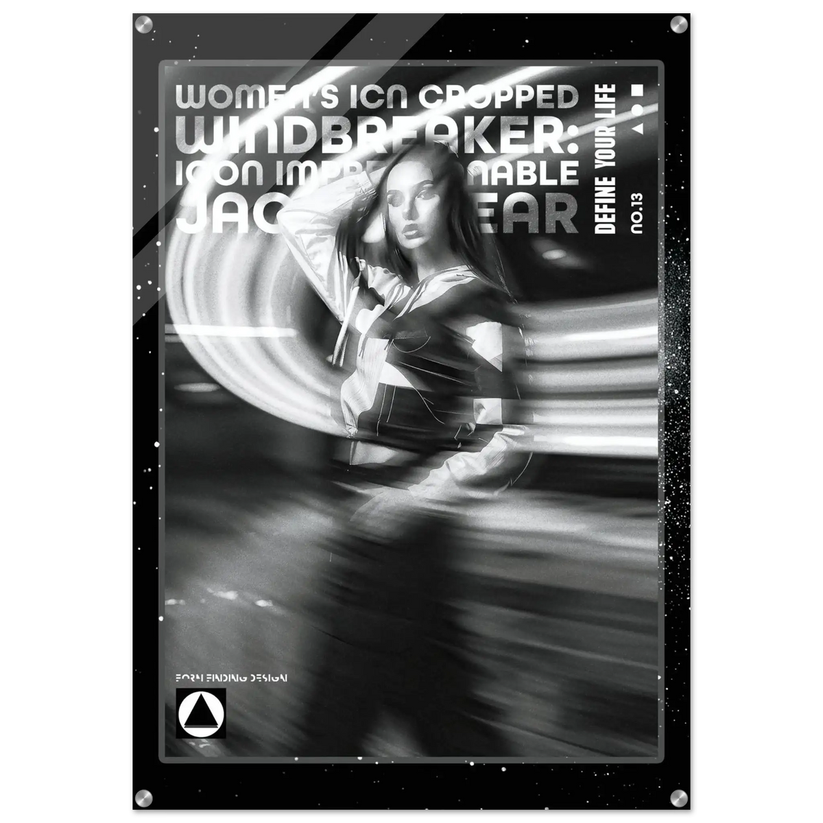 A black and white graphic poster or print featuring a stylized woman with motion-blur effects and bold text reading 'WOMEN'S ICON CROPPED WINDBREAKER' and 'DEFINE YOUR LIFE'. The design is monochrome with a dark border and small white speckles, shown against a light gray background.