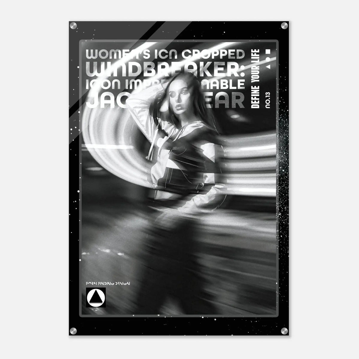 A black and white fashion poster featuring a woman in motion with dramatic light streaks, surrounded by a black border with text including 'WOMEN'S ICON CROPPED WINDBREAKER: ICON IMPRESSIONABLE JACKETWEAR' and 'DEFINE YOUR LIFE NO.13'.