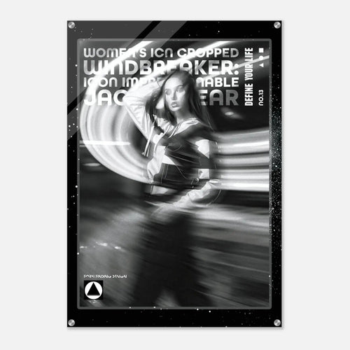 A black and white fashion poster featuring a woman in motion with dramatic light streaks, surrounded by a black border with text including 'WOMEN'S ICON CROPPED WINDBREAKER: ICON IMPRESSIONABLE JACKETWEAR' and 'DEFINE YOUR LIFE NO.13'.