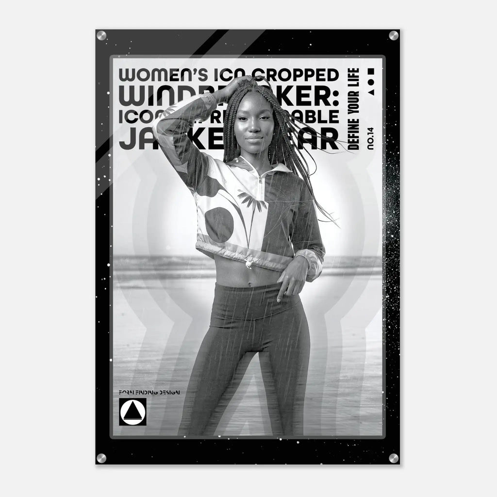A black-framed poster print featuring a grayscale photo of a woman posing in cropped windbreaker clothing, with bold text reading 'WOMEN'S ICON CROPPED WINDBREAKER: ICON IMPRESSIONABLE JACKETWEAR' and smaller text 'DEFINE YOUR LIFE NO.14'.