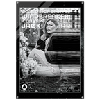 A black and white fashion poster print featuring a seated woman in a dark jacket and light pants, with bold text overlays including 'WOMEN'S ICON IMPRESSIONABLE JACKETWEAR'. The poster is shown hanging against a white wall with visible wall hooks at the corners.