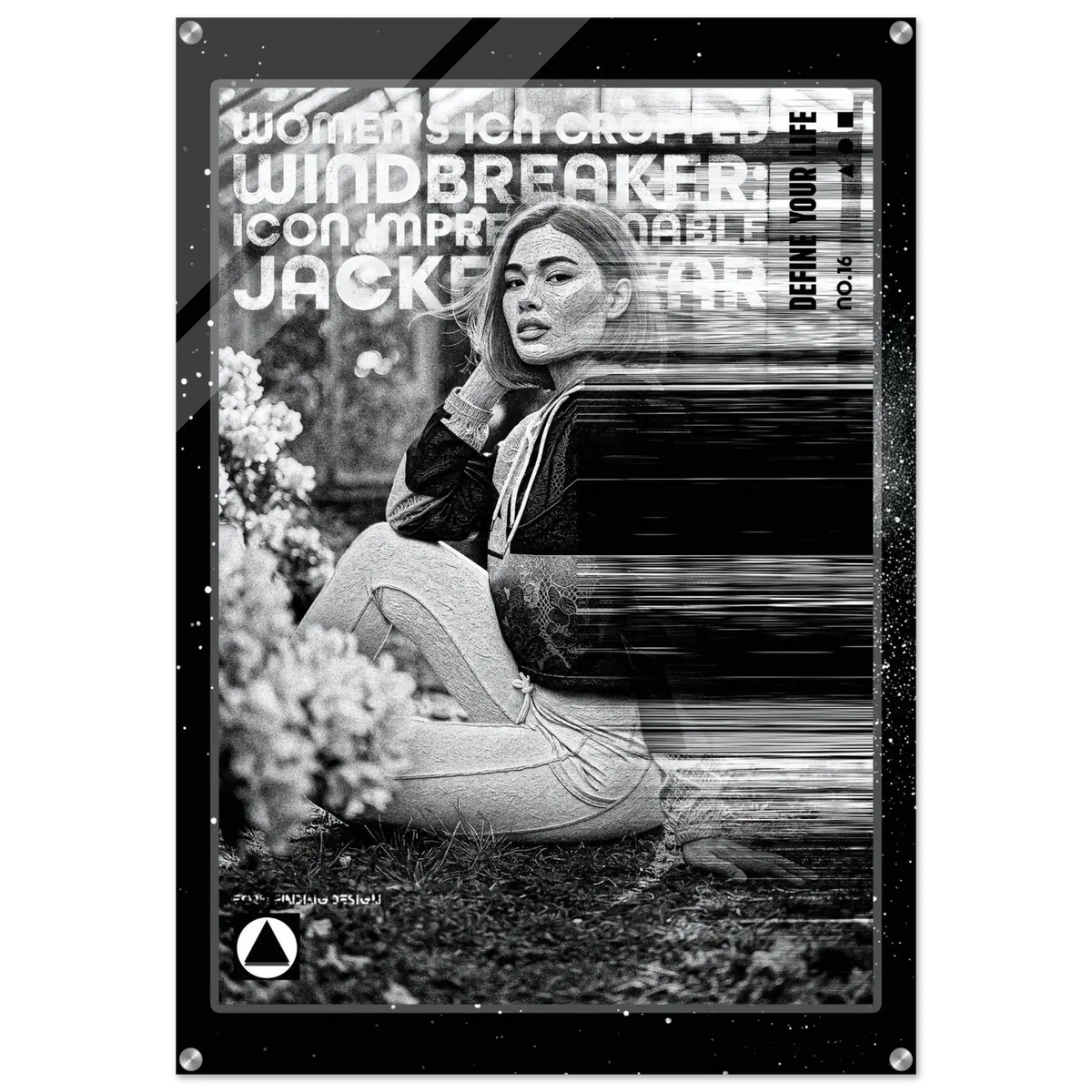 A black and white fashion poster print featuring a seated woman in a dark jacket and light pants, with bold text overlays including 'WOMEN'S ICON IMPRESSIONABLE JACKETWEAR'. The poster is shown hanging against a white wall with visible wall hooks at the corners.