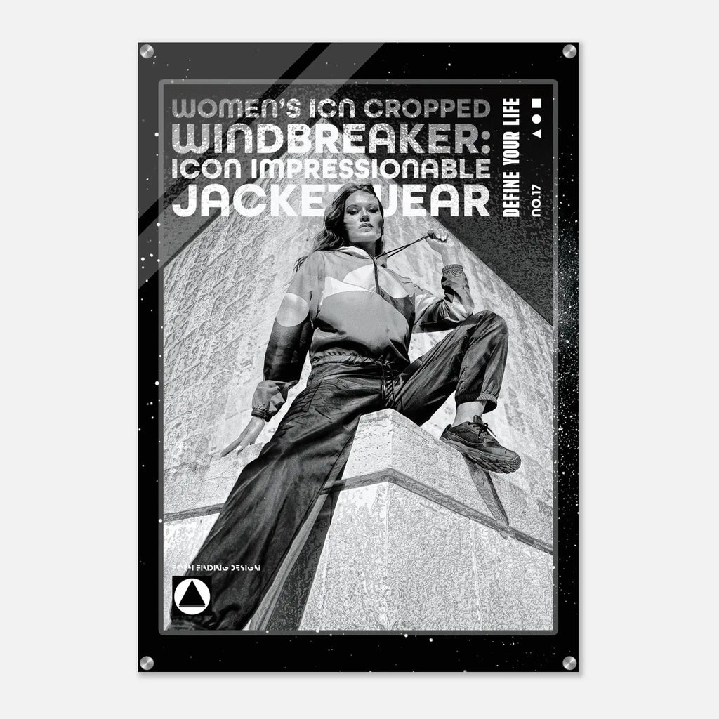 A black poster print featuring a black-and-white photo of a woman in a cropped windbreaker jacket sitting on a stone structure, with bold text reading 'WOMEN'S ICON CROPPED WINDBREAKER: ICON IMPRESSIONABLE JACKETWEAR' and 'DEFINE YOUR LIFE'.
