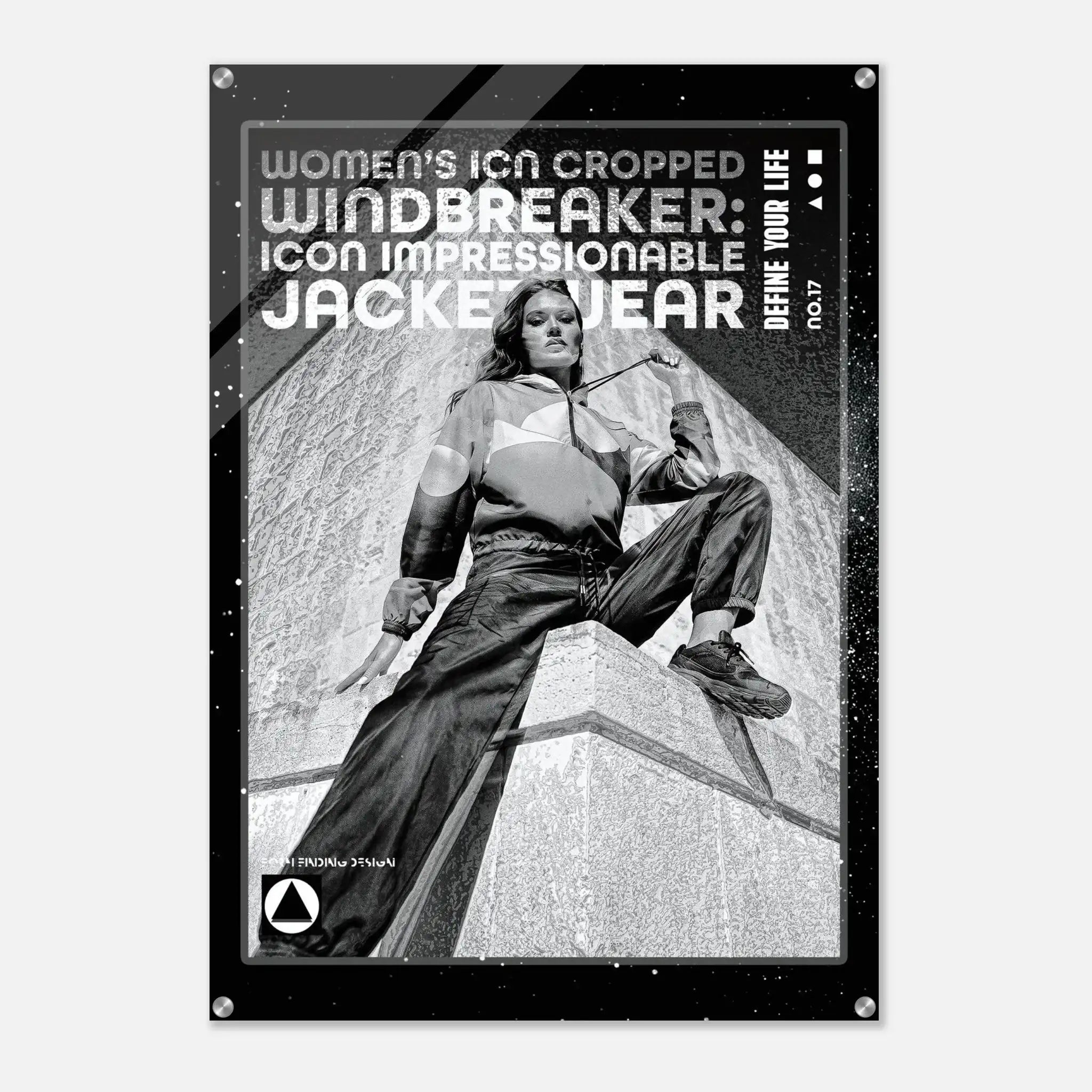 A black poster print featuring a black-and-white photo of a woman in a cropped windbreaker jacket sitting on a stone structure, with bold text reading 'WOMEN'S ICON CROPPED WINDBREAKER: ICON IMPRESSIONABLE JACKETWEAR' and 'DEFINE YOUR LIFE'.