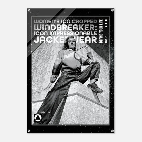 A black poster print featuring a black-and-white photo of a woman in a cropped windbreaker jacket sitting on a stone structure, with bold text reading 'WOMEN'S ICON CROPPED WINDBREAKER: ICON IMPRESSIONABLE JACKETWEAR' and 'DEFINE YOUR LIFE'.