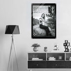 A black and white fashion poster featuring a woman sitting on a rock, with the text 'women's icon cropped windbreaker icon impressionable jacketwear' and a small circular logo, displayed on a wall above a shelf in a modern styled room.