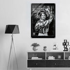 A black and white poster featuring a woman with the text 'WOMEN ICON CROPPED WINDBREAKER' hangs on a light gray wall above a shelf with decor items in a modern room setting.