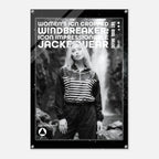 A black-framed acrylic wall art print featuring a black-and-white photo of a woman in a striped zip-up top and dark pants, with large white text reading 'WOMEN'S ICON CROPPED WINDBREAKER: ICON IMPRESSIONABLE JACKETWEAR' and smaller text 'DEFINE YOUR LIFE'.