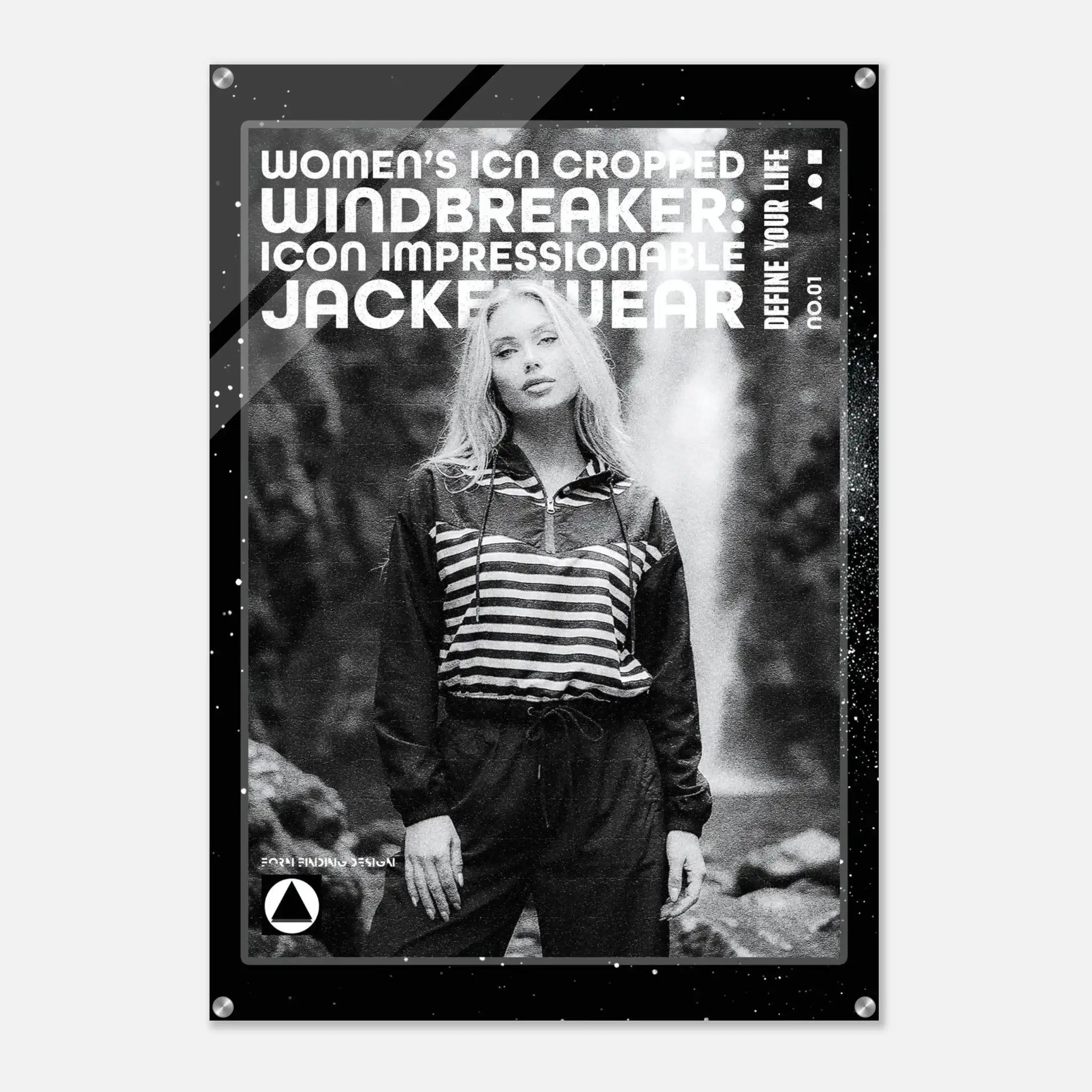 A black-framed acrylic wall art print featuring a black-and-white photo of a woman in a striped zip-up top and dark pants, with large white text reading 'WOMEN'S ICON CROPPED WINDBREAKER: ICON IMPRESSIONABLE JACKETWEAR' and smaller text 'DEFINE YOUR LIFE'.
