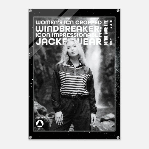 A black-framed acrylic wall art print featuring a black-and-white photo of a woman in a striped zip-up top and dark pants, with large white text reading 'WOMEN'S ICON CROPPED WINDBREAKER: ICON IMPRESSIONABLE JACKETWEAR' and smaller text 'DEFINE YOUR LIFE'.