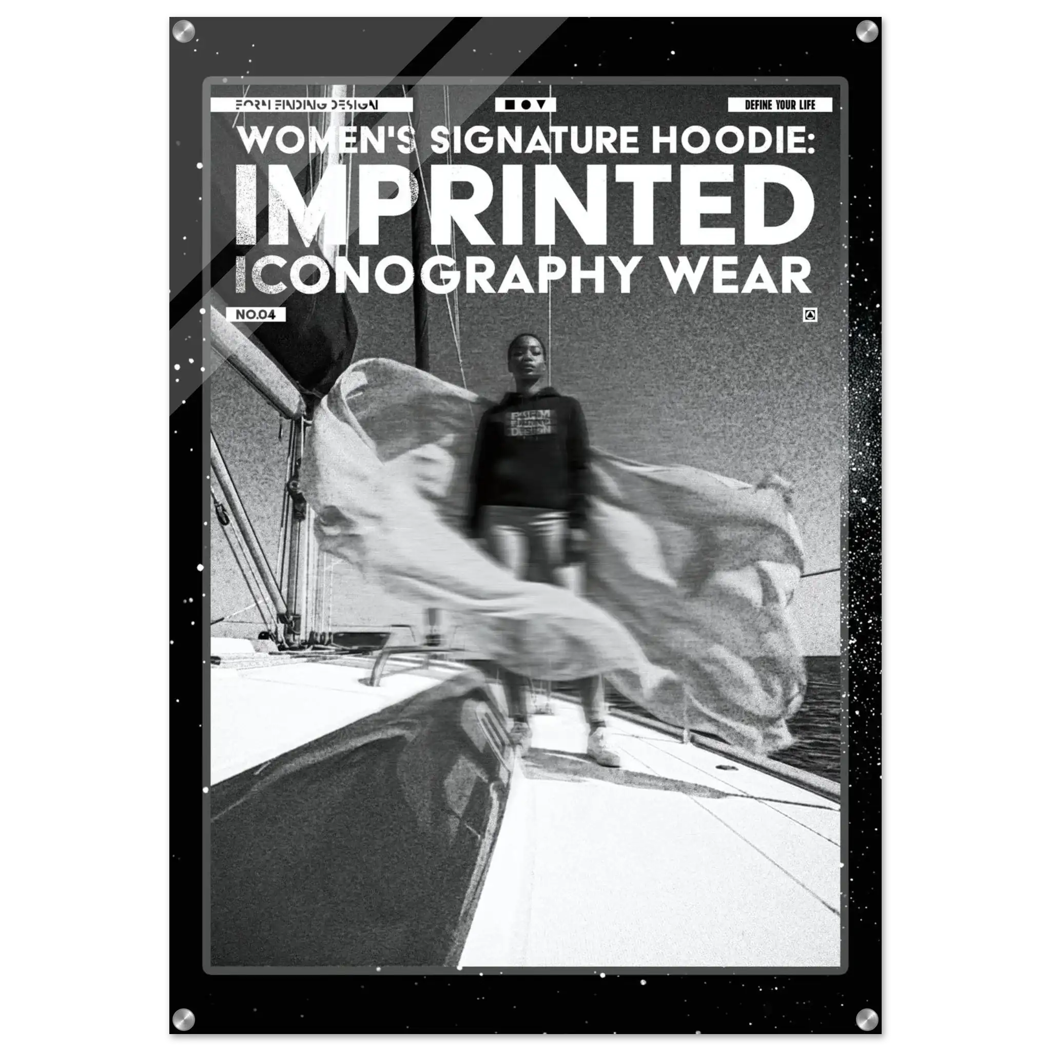 A black rectangular poster or print with rounded corners and visible mounting holes, featuring bold white text reading 'WOMEN'S SIGNATURE HOODIE: IMPRINTED ICONOGRAPHY WEAR' above a black-and-white photo of a person standing on a boat deck with flowing fabric. The product is shown against a light gray background.