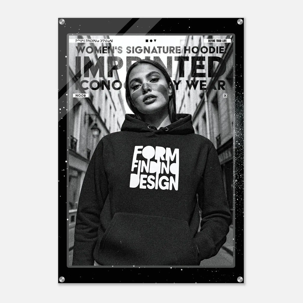 A black-framed poster or print featuring a black-and-white fashion photo of a woman wearing a hoodie with the words 'FORM FINDING DESIGN' in large white letters. The poster includes additional text at the top and is shown against a light gray background.