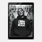 A black-framed poster or print featuring a black-and-white fashion photo of a woman wearing a hoodie with the words 'FORM FINDING DESIGN' in large white letters. The poster includes additional text at the top and is shown against a light gray background.