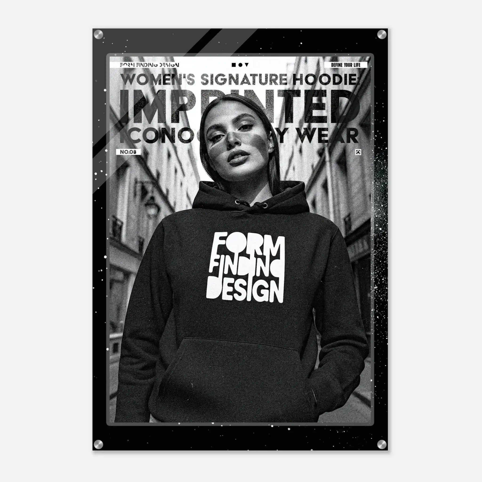 A black-framed poster or print featuring a black-and-white fashion photo of a woman wearing a hoodie with the words 'FORM FINDING DESIGN' in large white letters. The poster includes additional text at the top and is shown against a light gray background.
