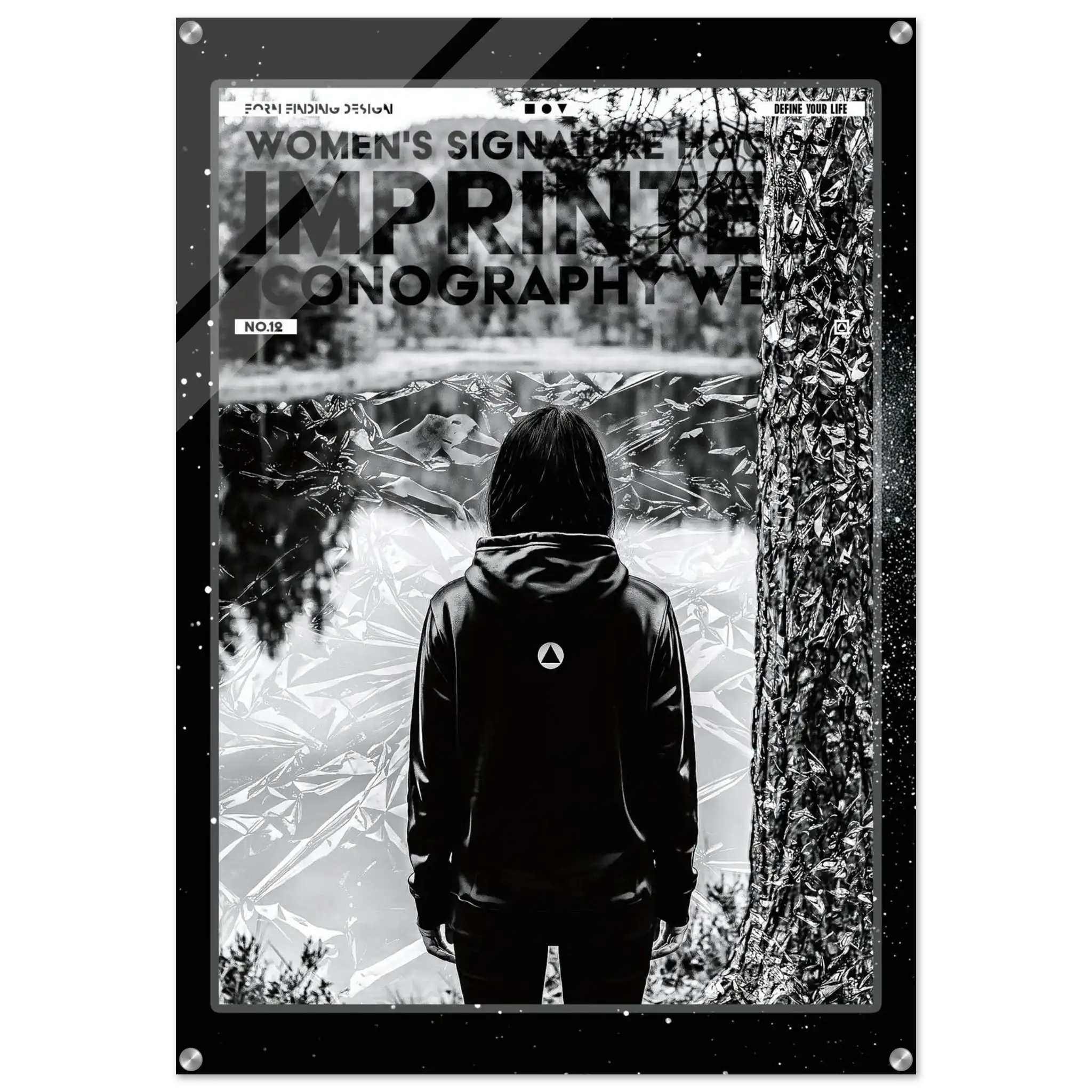 A black and white art print poster titled 'IMPRINTED ICONOGRAPHY WEAR' from 'WOMEN'S SIGNATURE HOODIE' featuring a person in a black hoodie seen from behind, standing in front of a tree and reflective water, with a black frame border.