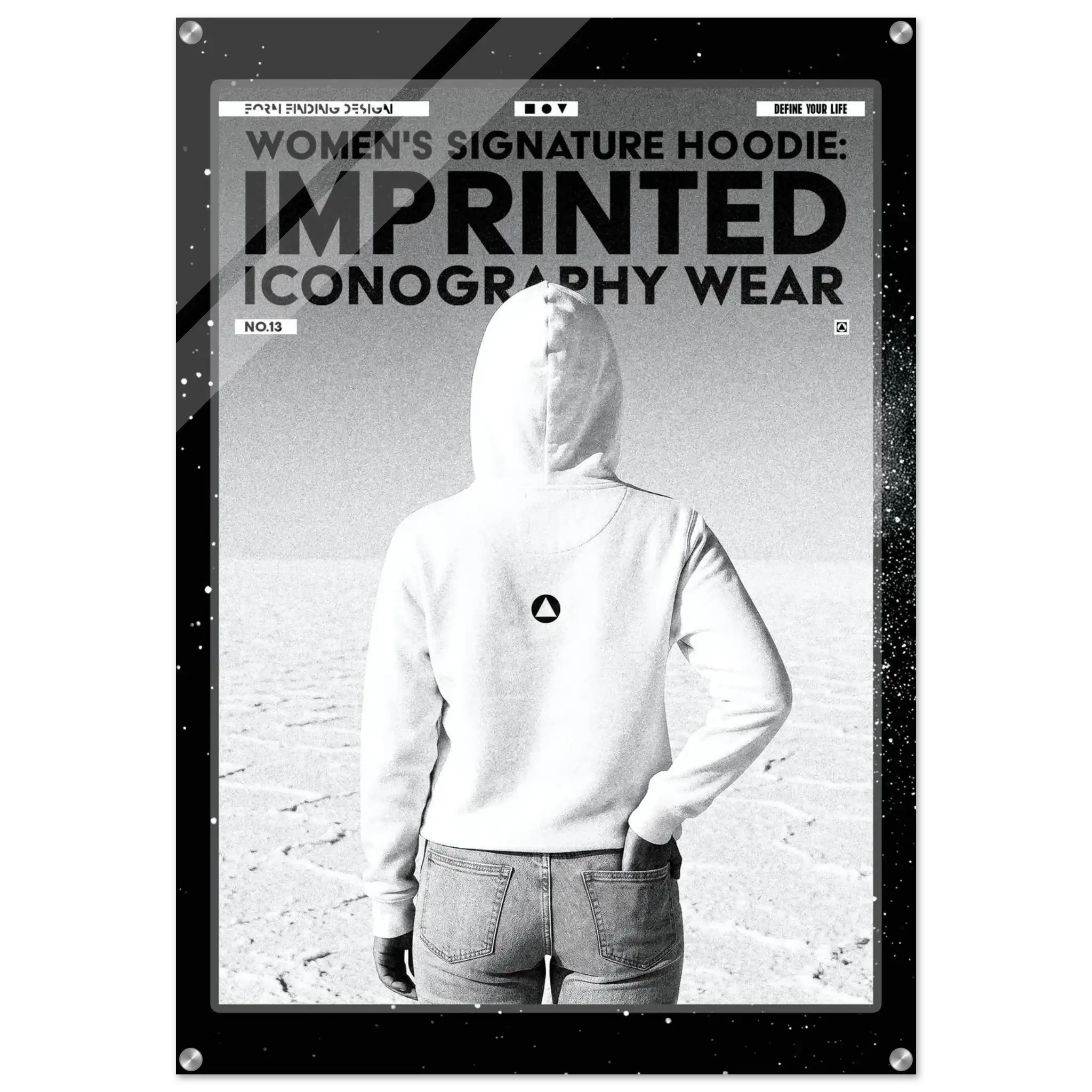 A black and white promotional poster-style image showing a person from behind wearing a white hoodie with a small circular logo on the back, standing in a flat desert landscape. Large text at the top reads 'WOMEN'S SIGNATURE HOODIE: IMPRINTED ICONOGRAPHY WEAR.