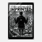 A black and white graphic poster featuring a person sitting on a swing above a cityscape, with bold text reading 'WOMEN'S SIGNATURE HOODIE: IMPRINTED ICONOGRAPHY WEAR' and a circular logo on the back of the hoodie. The poster is shown centered on a light gray background.