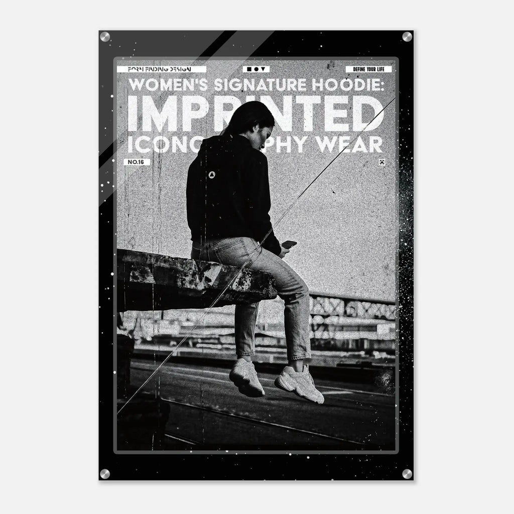 A black and white fashion poster print featuring a seated person in a dark hoodie and jeans, with large distressed text reading 'WOMEN'S SIGNATURE HOODIE: IMPRINTED ICONOGRAPHY WEAR' and 'NO. 16'.