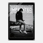 A black and white fashion poster print featuring a seated person in a dark hoodie and jeans, with large distressed text reading 'WOMEN'S SIGNATURE HOODIE: IMPRINTED ICONOGRAPHY WEAR' and 'NO. 16'.