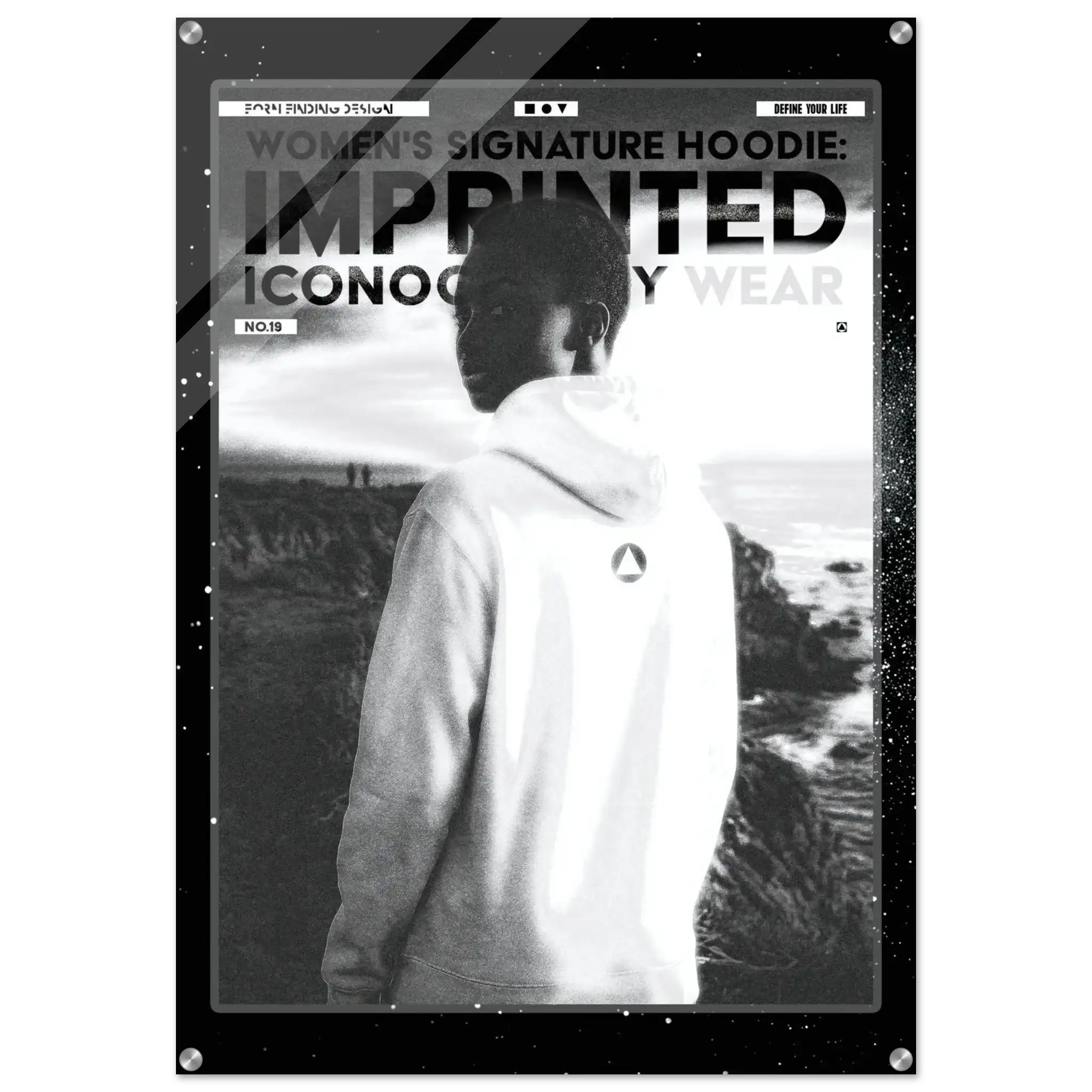A black and white promotional poster or print featuring a person in a white hoodie standing outdoors, with large text reading 'WOMEN'S SIGNATURE HOODIE: IMPRINTED ICONOGRAPHY WEAR' and a branded logo on the back of the hoodie. The print is shown against a dark background with a subtle border.