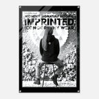 A black and white fashion poster featuring a seated woman from behind wearing a hoodie, with large text reading 'WOMEN'S SIGNATURE HOODIE' and 'IMPRINTED ICONOGRAPHY WEAR'. The poster is shown centered on a light gray background with a black border and small corner fasteners visible.