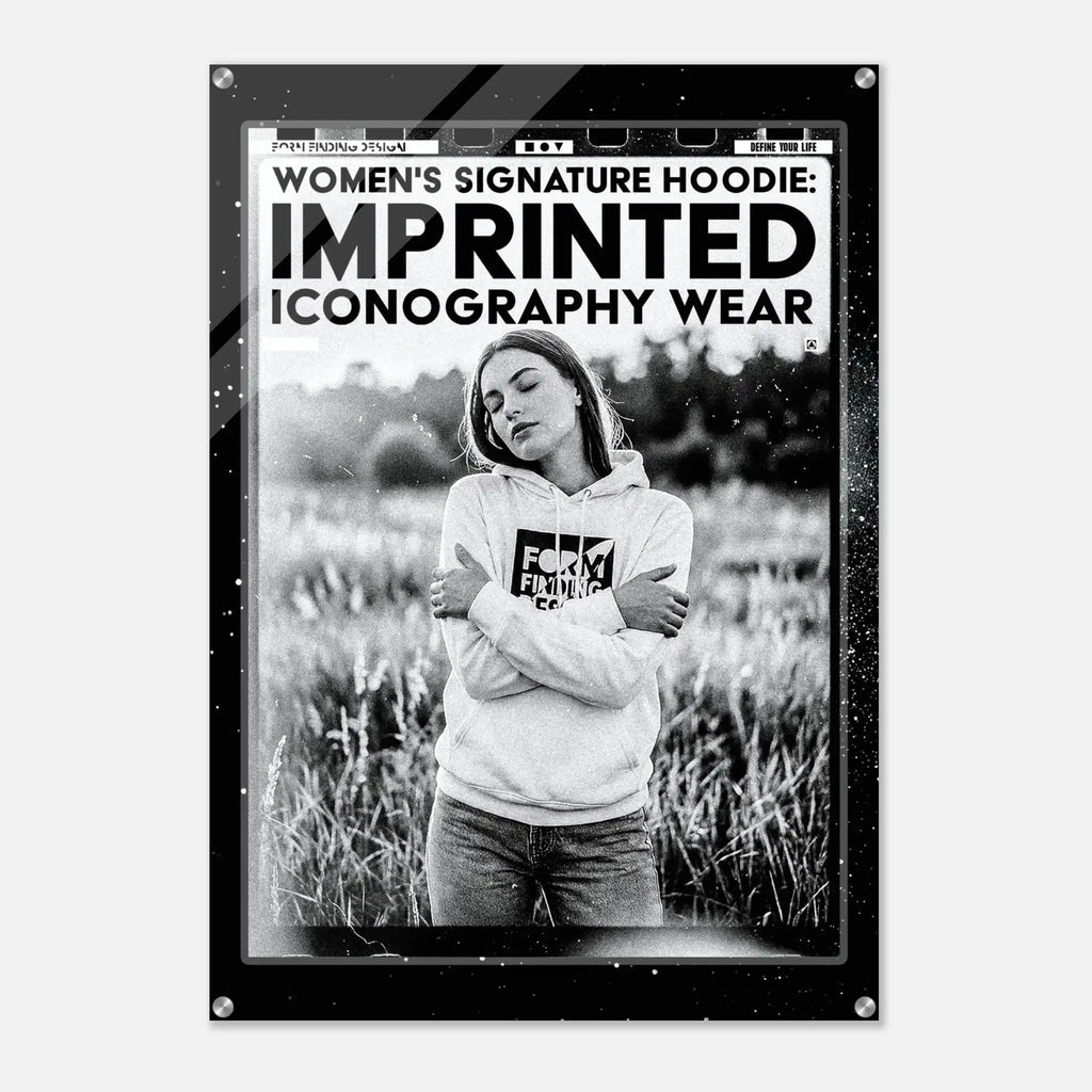 A black-framed art print or poster featuring a black-and-white photograph of a woman in a hoodie standing in a field, with bold text at the top reading 'WOMEN'S SIGNATURE HOODIE: IMPRINTED ICONOGRAPHY WEAR.'.