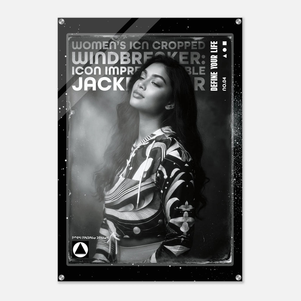 A black and white poster print featuring a portrait of a woman in a patterned jacket, with bold text reading 'WOMEN'S ICON CROPPED WINDBREAKER: ICON IMPRESSIONABLE JACKETWEAR' and 'DEFINE YOUR LIFE'.