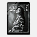 A black and white poster print featuring a portrait of a woman in a patterned jacket, with bold text reading 'WOMEN'S ICON CROPPED WINDBREAKER: ICON IMPRESSIONABLE JACKETWEAR' and 'DEFINE YOUR LIFE'.