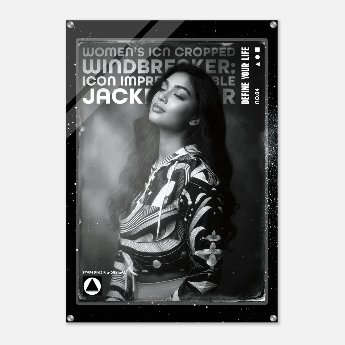 A black and white poster print featuring a portrait of a woman in a patterned jacket, with bold text reading 'WOMEN'S ICON CROPPED WINDBREAKER: ICON IMPRESSIONABLE JACKETWEAR' and 'DEFINE YOUR LIFE'.
