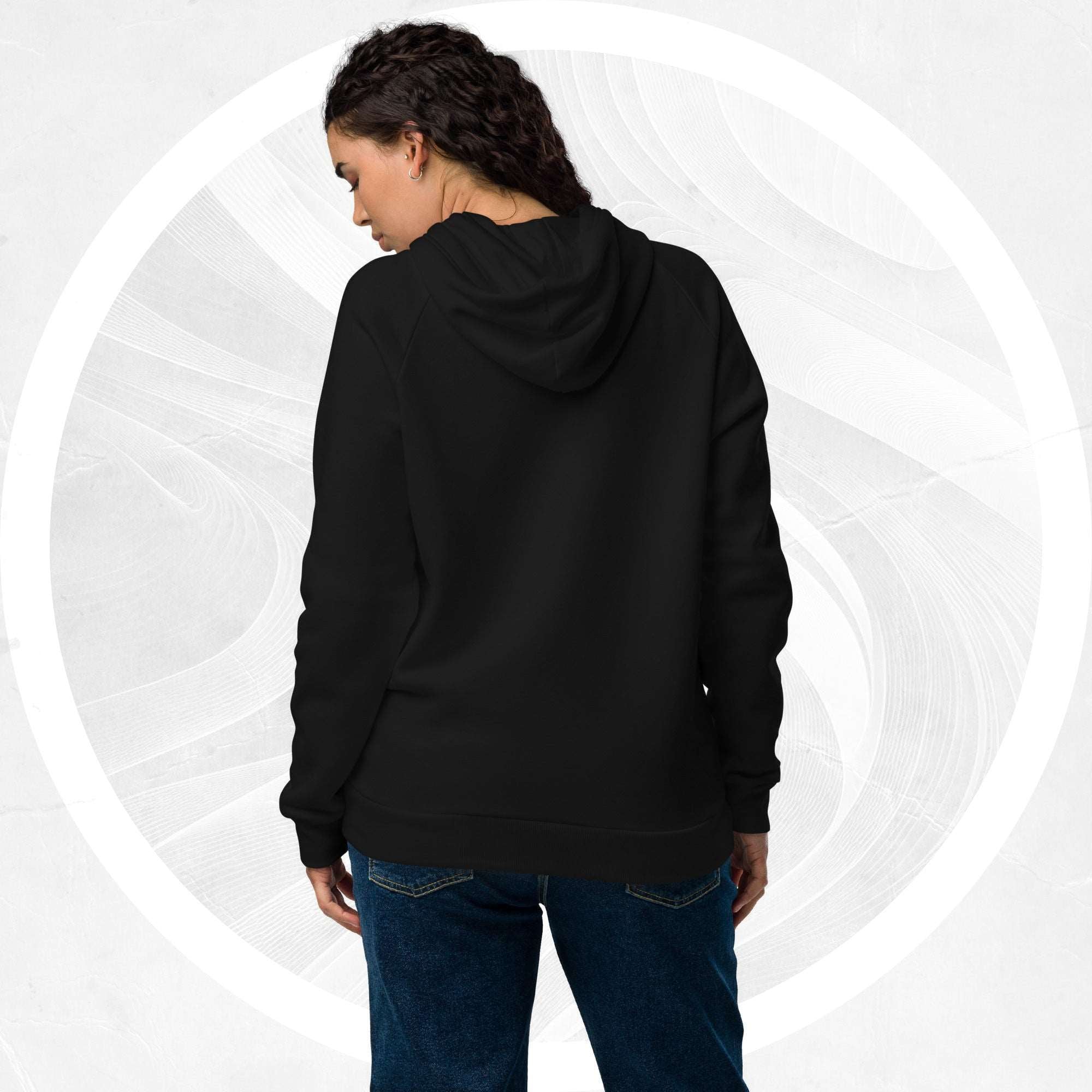 Back view of model wearing the black Form Finding Design Under Armour® x Ring Stamp Hoodie (No.05); plain back panel with hood and relaxed silhouette, showing cuffs and hem.