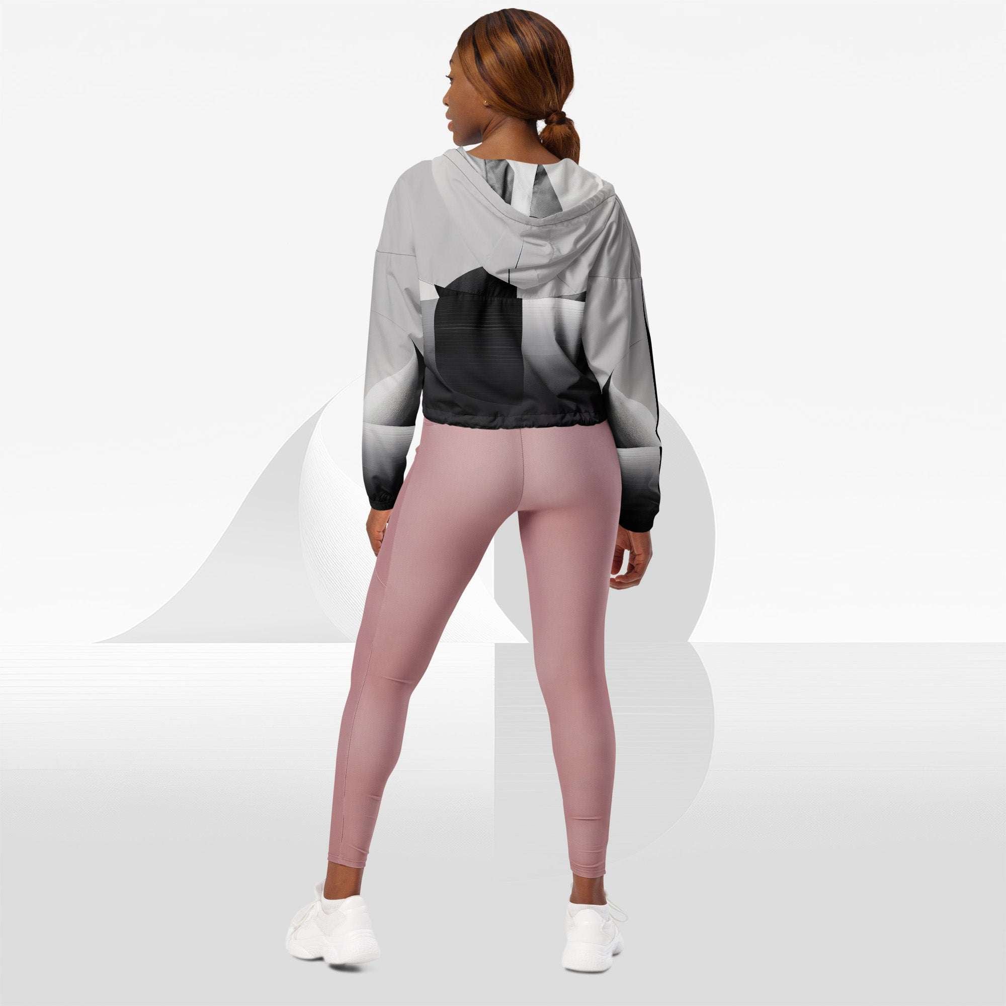 Back view on model: Form Finding Design ICN Cropped Windbreaker Print No.15—hood and back panel show continuous monochrome geometric stripe artwork, cropped hem with adjustable drawcord.