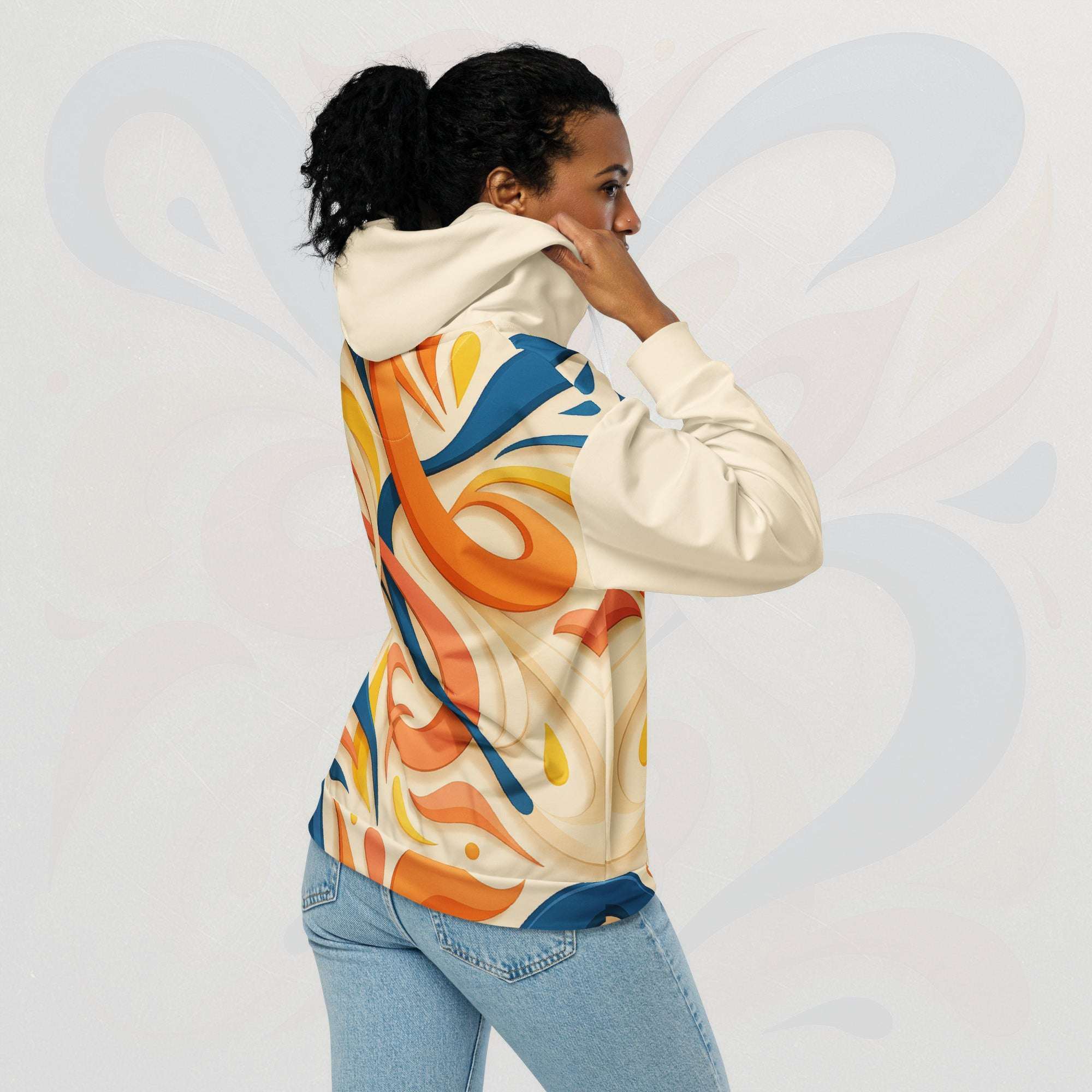 Upper-body back pose of a model wearing FormFD Women’s Coral Canvas Hoodie (No.10)—hood up in hand, showcasing the large abstract swirl artwork across the back panel in coral orange, teal blue and yellow and cream.