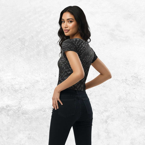 Three-quarter side/back view of model in Form Finding Design Women’s Era Print (No.15) crop tee — distressed monochrome newsprint collage print, cropped hem, fitted sleeves, paired with black jeans.