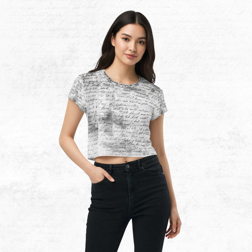 Model wearing Form Finding Design Women’s Era Print (No.20) cropped tee — black-and-white newsprint collage pattern across torso and sleeves, crew neck, styled with black jeans.