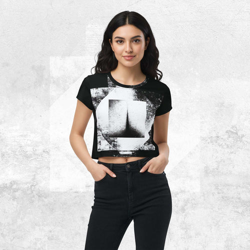 Model wearing Form Finding Design Women’s Era Stamp (No.11) crop tee; bold monochrome distressed geometry print on the front, styled with black jeans against a soft black textured backdrop.