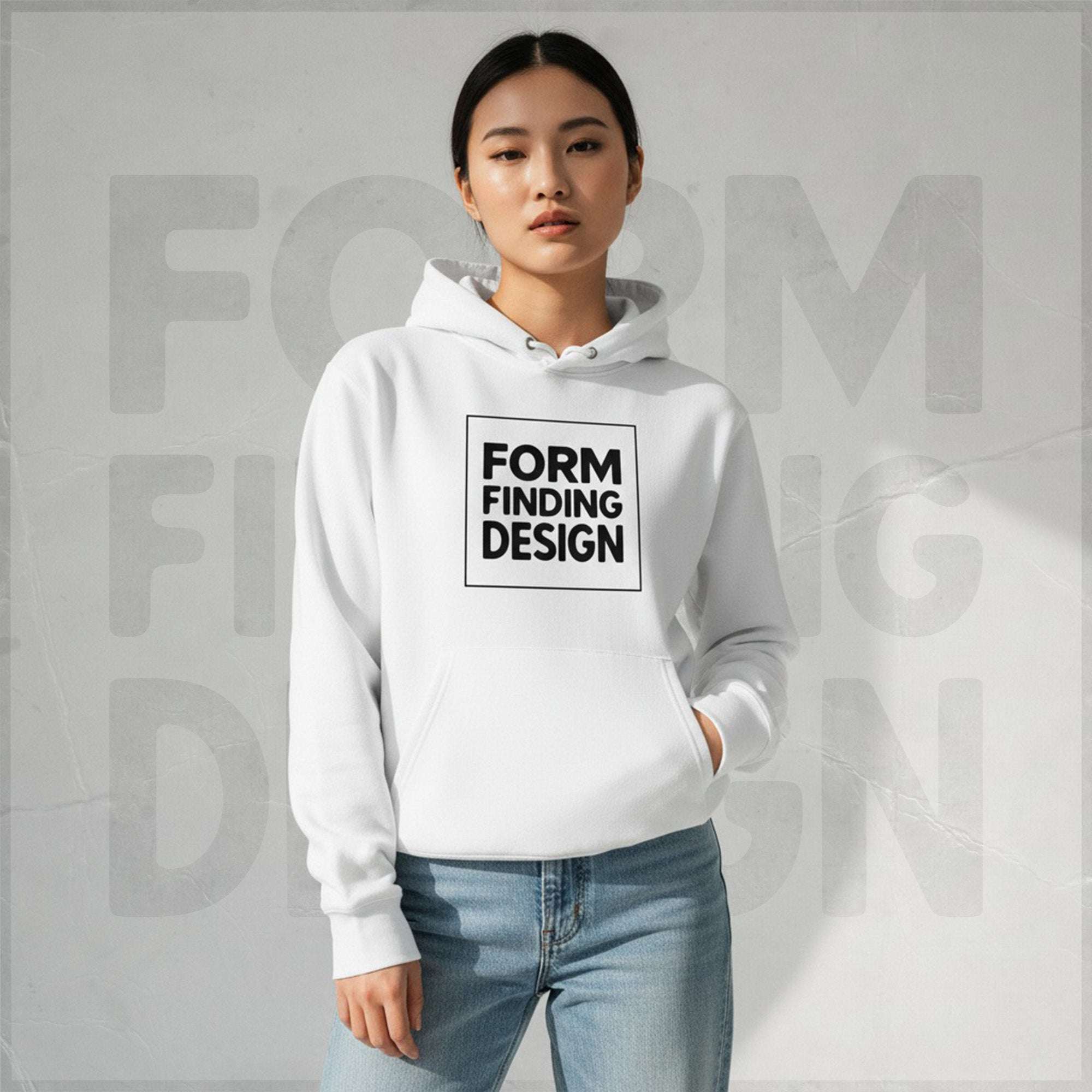 Lifestyle front portrait: model in white Form Finding Design Women’s Signature Hoodie (FFD-17)—black square logo print, kangaroo pocket, casual fit with light denim.
