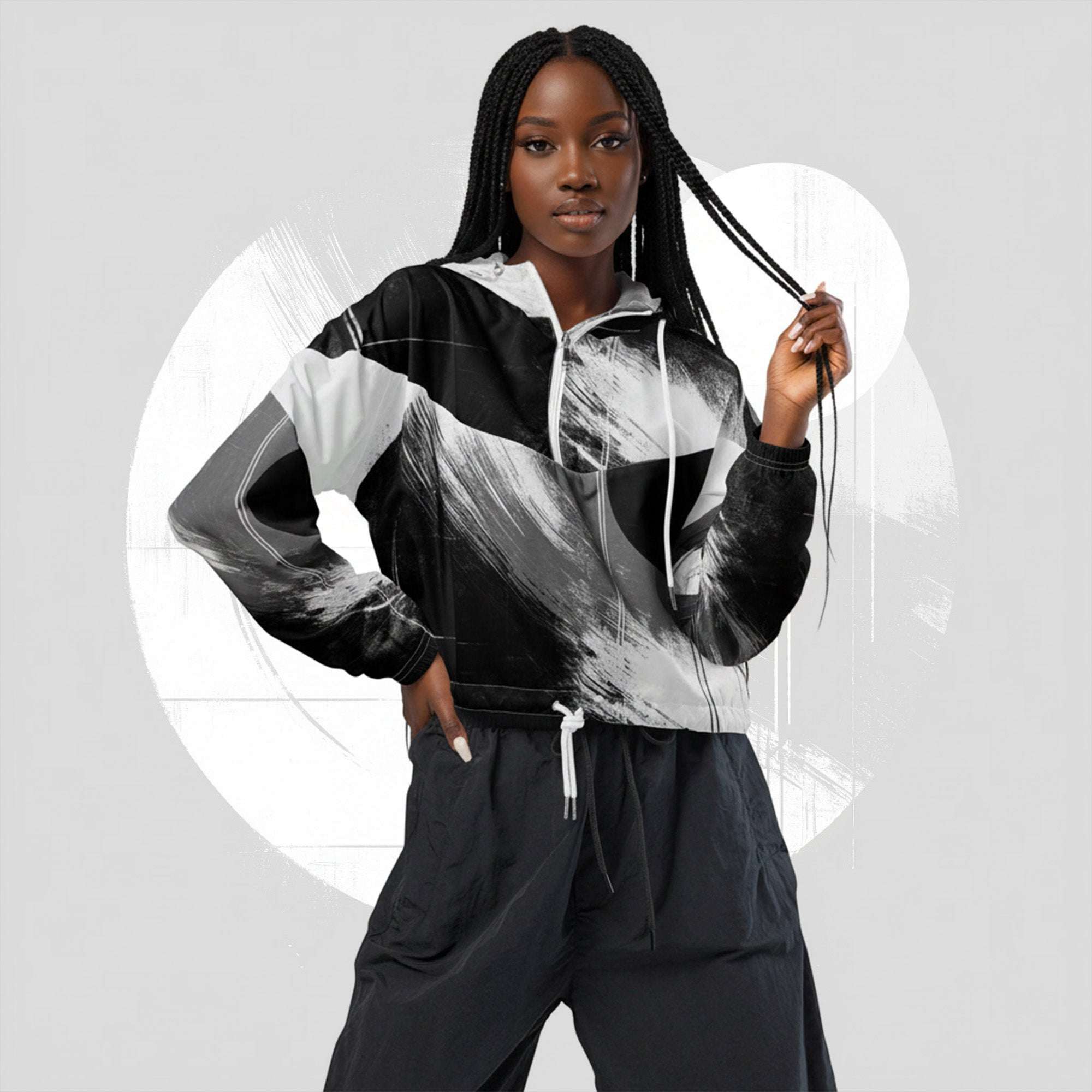 Second lifestyle pose in ICN Cropped Windbreaker No.10—monochrome black-and-white stripe print emphasised across chest and sleeves, cropped silhouette with drawcord hem from Form Finding Design.