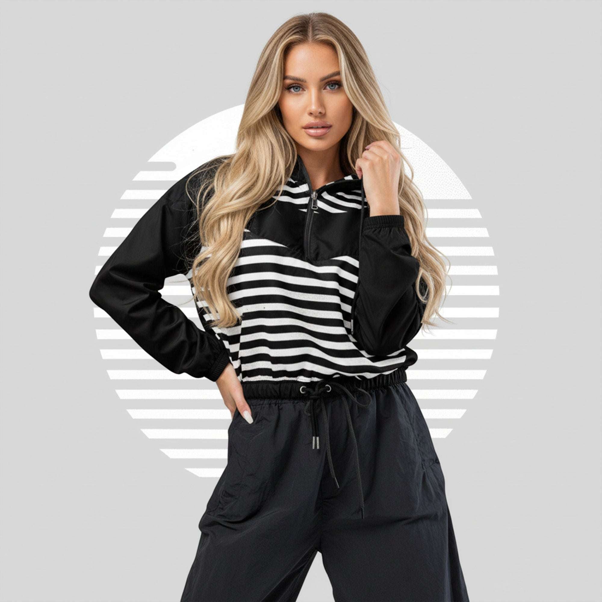 Second lifestyle pose in ICN Cropped Windbreaker—monochrome black-and-white stripe print emphasised across chest and sleeves, cropped silhouette with drawcord hem from Form Finding Design.