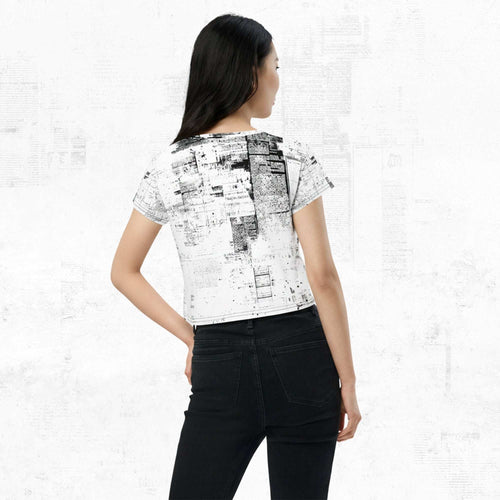 Three-quarter side/back view of model in Form Finding Design Women’s Era Print (No.04) crop tee — distressed monochrome newsprint collage print, cropped hem, fitted sleeves, paired with black jeans.